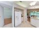 Kitchen featuring a side-by-side refrigerator, tiled floors, and a view of the breakfast nook at 5513 83Rd E Ter, Sarasota, FL 34243