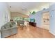 Spacious living room featuring wood floors, vaulted ceiling with fan, and an open floor plan at 5513 83Rd E Ter, Sarasota, FL 34243