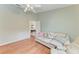 Cozy living room featuring light green walls, a ceiling fan, and a comfortable white couch with patterned pillows at 5513 83Rd E Ter, Sarasota, FL 34243