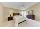 Comfortable bedroom featuring neutral walls, a ceiling fan, and classic wooden furniture at 5513 83Rd E Ter, Sarasota, FL 34243