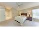 Comfortable bedroom with neutral carpet, ceiling fan, and a door to the bathroom at 5513 83Rd E Ter, Sarasota, FL 34243