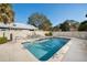 Private backyard swimming pool with patio furniture, a white fence, and clear blue water at 5513 83Rd E Ter, Sarasota, FL 34243