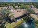 Aerial view of property with a beautiful pond view from the patio, surrounded by mature trees at 5618 Monte Rosso Rd, Sarasota, FL 34243