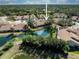 Aerial view of property overlooking a tranquil pond, showcasing the community and surrounding landscape at 5618 Monte Rosso Rd, Sarasota, FL 34243