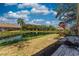 Picturesque backyard featuring a tranquil pond, lush landscaping, and a brick paver patio at 5618 Monte Rosso Rd, Sarasota, FL 34243