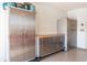 Organized garage with rolling cabinets for ample storage, workbench, and epoxy flooring at 5618 Monte Rosso Rd, Sarasota, FL 34243