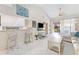 Bright living room offers white tile floors, a breakfast bar, and sliding glass doors to the outside patio at 5618 Monte Rosso Rd, Sarasota, FL 34243