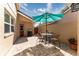 Private patio featuring brick flooring, a dining set with an umbrella, and a grill, ideal for outdoor enjoyment at 5618 Monte Rosso Rd, Sarasota, FL 34243