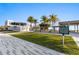 View of Siesta Key Public Beach featuring a modern building, palm trees, and open green space at 5618 Monte Rosso Rd, Sarasota, FL 34243