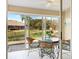 Inviting sunroom with scenic water views, a round dining table, and wicker chairs at 5618 Monte Rosso Rd, Sarasota, FL 34243