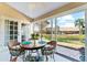 Inviting sunroom with scenic water views, a round dining table, and wicker chairs at 5618 Monte Rosso Rd, Sarasota, FL 34243