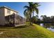 Lush backyard with a screened lanai and serene pond views at 5638 Oakshire Ave, Sarasota, FL 34233