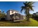 Expansive backyard featuring a screened lanai and verdant lawn at 5638 Oakshire Ave, Sarasota, FL 34233