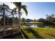 Picturesque backyard view with a screened lanai overlooking the pond at 5638 Oakshire Ave, Sarasota, FL 34233