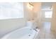 Bathroom with a soaking tub, double vanity, and an open door to the rest of the home at 5638 Oakshire Ave, Sarasota, FL 34233