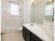 Bright bathroom featuring a shower and tub combo, vanity with sink, and tiled flooring at 5638 Oakshire Ave, Sarasota, FL 34233