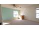 Spacious bedroom with two windows, carpet floor, and a ceiling fan at 5638 Oakshire Ave, Sarasota, FL 34233