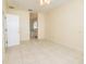 Spacious bedroom with neutral walls, tile flooring, and a doorway leading to the attached bathroom at 5638 Oakshire Ave, Sarasota, FL 34233