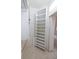 Walk-in closet featuring built-in shelving and tile flooring with an open door to the bathroom at 5638 Oakshire Ave, Sarasota, FL 34233