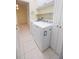 Bright laundry room with white cabinets and washer and dryer at 5638 Oakshire Ave, Sarasota, FL 34233