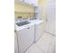 Bright laundry room with a white washer and dryer set at 5638 Oakshire Ave, Sarasota, FL 34233