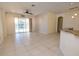 Open living room featuring tile flooring, ceiling fan, and sliding glass doors to the lanai at 5638 Oakshire Ave, Sarasota, FL 34233