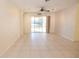 Tile living room with ceiling fan, track lighting, and sliding glass doors to backyard view at 5638 Oakshire Ave, Sarasota, FL 34233