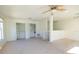 Spacious bonus room featuring carpet flooring, a ceiling fan and two closets at 5638 Oakshire Ave, Sarasota, FL 34233