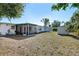 Spacious backyard featuring a well-maintained lawn and access to both a shed and screened in patio at 5724 25Th W St, Bradenton, FL 34207