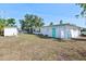 Large backyard featuring a well-kept lawn, a storage shed, and plenty of open space at 5724 25Th W St, Bradenton, FL 34207