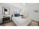 Bedroom featuring shiplap walls, neutral decor, and light-filled windows at 615 Avenida Del Norte, Sarasota, FL 34242