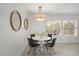 Cozy dining room featuring a round table, modern chairs, and plantation shutters that allow natural light to illuminate the space at 615 Avenida Del Norte, Sarasota, FL 34242