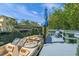 Private dock with boat, featuring a serene canal and tropical views at 615 Avenida Del Norte, Sarasota, FL 34242