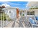 Attractive home exterior featuring a mix of white siding and wood accents, with a welcoming patio area at 615 Avenida Del Norte, Sarasota, FL 34242