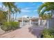 Welcoming home exterior features a white fence, well-maintained landscaping, and a charming covered entrance at 615 Avenida Del Norte, Sarasota, FL 34242