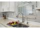 Well-lit kitchen sink with modern faucet, granite countertop, and tiled backsplash at 615 Avenida Del Norte, Sarasota, FL 34242