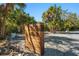 Modern wood mailbox adds curb appeal to this private residence nestled among mature palm trees at 615 Avenida Del Norte, Sarasota, FL 34242