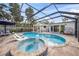 Stunning screened-in pool area with spa, lounge seating, and outdoor dining space at 615 Avenida Del Norte, Sarasota, FL 34242