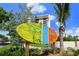 Vibrant sign for Siesta Key Village against a blue sky and tropical landscape at 615 Avenida Del Norte, Sarasota, FL 34242