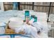 Elegant outdoor table setting for eight, with white linens, wicker accents, and blue glass accents at 615 Avenida Del Norte, Sarasota, FL 34242