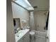 Bright bathroom with a skylight, white tile, marble floors, and modern fixtures at 6330 7Th W Ave, Bradenton, FL 34209