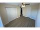 Bedroom with a double door closet, ceiling fan, and hardwood floors at 6330 7Th W Ave, Bradenton, FL 34209