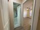 Hallway showing entry to bathroom and a bedroom with a ceiling fan and a window at 6330 7Th W Ave, Bradenton, FL 34209