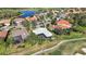 Aerial view of a home with screened in lanai and lush tropical landscaping at 6626 The Masters Ave, Lakewood Ranch, FL 34202