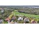 Scenic aerial of homes overlooking a golf course and natural wooded area at 6626 The Masters Ave, Lakewood Ranch, FL 34202