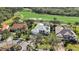 Aerial view of a home with lush landscaping near a golf course at 6626 The Masters Ave, Lakewood Ranch, FL 34202