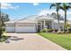 Beautiful home featuring a paver driveway, three-car garage, tile roof and meticulously manicured lawn at 6626 The Masters Ave, Lakewood Ranch, FL 34202