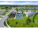 An aerial view of community amenities: pool, playground, basketball court, and a scenic lake at 6708 162Nd E Pl, Parrish, FL 34219