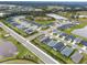 Aerial view of a neighborhood with homes, green spaces, and a small pond at 6708 162Nd E Pl, Parrish, FL 34219