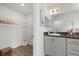 Bathroom featuring a single sink vanity, a lighted mirror, and a glimpse into the walk-in closet at 6708 162Nd E Pl, Parrish, FL 34219